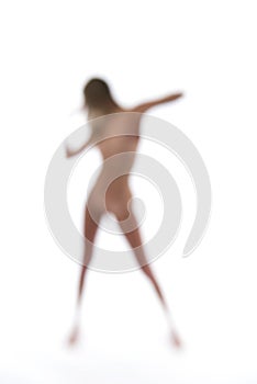 Blurry naked woman dancing on a white backdrop photo