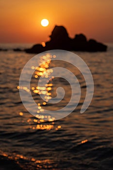 Blurry orange and golden skylight calmness relaxing summer mood. Sunset sky reflecting in the water. Blurred defocused