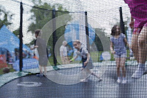 Blurry photo of kids having fun on a trampoline