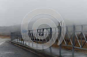 A blurry photo of a road barrier through fogged glass