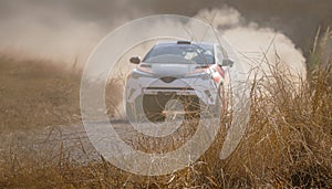 Blurry rally racing car on dirt track. photo