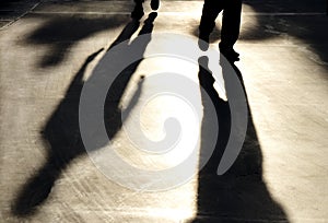 Blurry reflection shadow silhouette of  men walking on pedestrian road