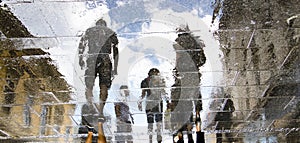 Blurry reflection silhouettes of people walking on a rainy day