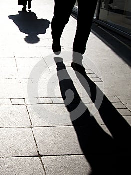 Blurry shadow silhouette of people walking, in black and white