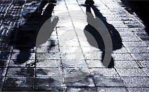 Blurry shadow and silhouette of two men standing in the night