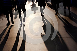 Blurry shadows of people walking on summer promenade