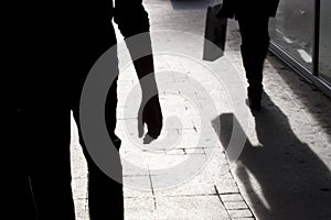 Blurry silhouette and shadows of two person walking