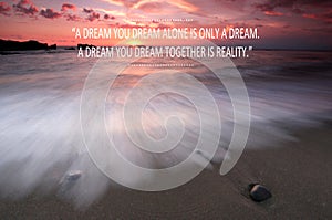 Blurry sunset on the beach with Inspirational quote - A dream you dream alone is only a dream , A dream you dream together is real