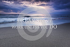 Blurry sunset on the beach with Inspirational quote -Dreams don`t work unless you do