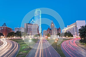 Blurred skyline and light trail traffic over Dealey Plaza in Dallas, Texas photo