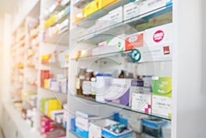 Blurry view of drug store and pharmacist. Blurred clean pharmacy with medicine on shelves. Defocus white drugstore