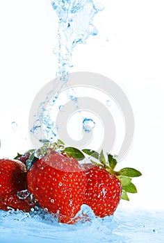 Blurry water being poured on strawberries