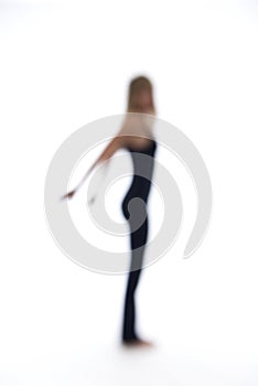 Blurry woman dancing on a white backdrop