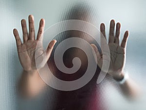 Blurry woman hand behind frosted glass metaphor panic and negative dark emotional