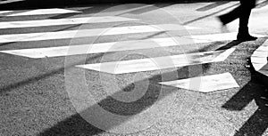 Blurry zebra crossing with person silhouette and shadow