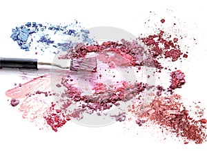 Blush make up cosmetic on crushed colorful eyeshadow glitter.