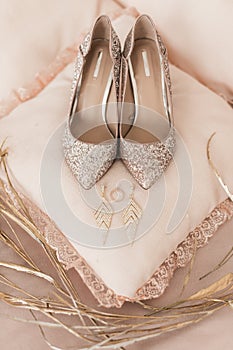 Blush pink bridal shoes and accenting jewelry and perfume