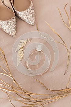 Blush pink bridal shoes and accenting jewelry and perfume