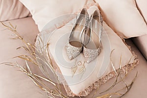 Blush pink bridal shoes and accenting jewelry and perfume