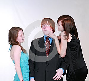Blushing boy and teen girls flirting photo