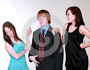 Blushing teen boy with girls