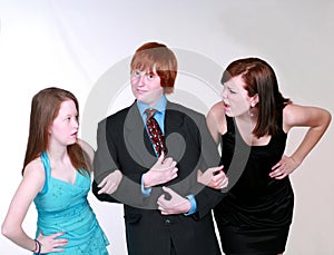 Blushing Teen boy with two girls photo