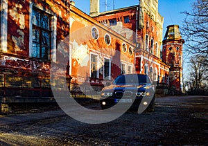 Bmw e39 and old building.