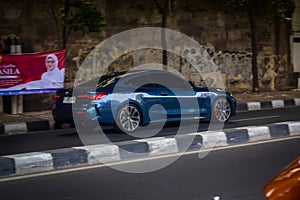 BMW 430i coupe G22 driving fast on the road