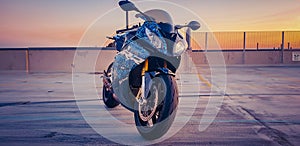 BMW S1000rr Motorcycle in carpark at sunset