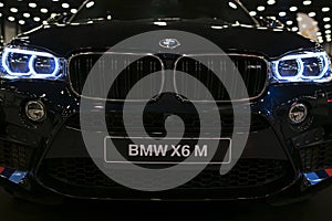 BMW X6M 2017. Headlight of a modern sport car. Front view of luxury sport car. Car exterior details.