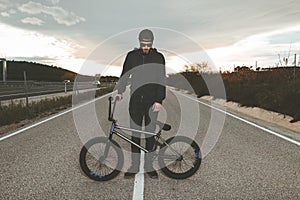 BMX rider doing tricks. Young man with a bmx bike. Extreme sports