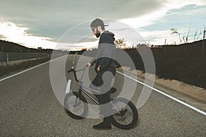 BMX rider doing tricks. Young man with a bmx bike. Extreme sports