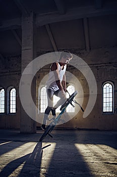 The BMX rider jumps with a bicycle.