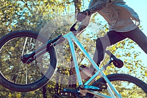 Bmx rider performing a tail whip at a quarter pipe ramp on a skatepark