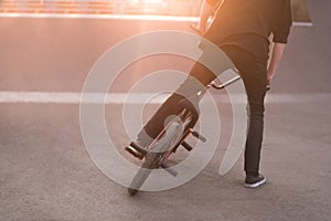 Bmx rider performs tricks on a bmx bike in a skate park on the background of the sunset. Bmx Concept. Copyspace