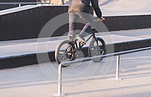 Bmx rider rides a bike on a park skate. Training of tricks on BMX