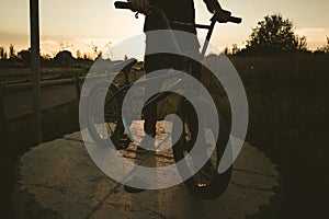 BMX rider at sunset. Guy riding a bmx bike