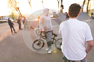 bmx riders at skate park at sunset background. Background with cyclists on bmx