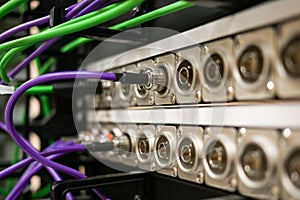 BNC patch panel with connected coaxial SDI cables