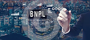 BNPL - Buy Now Pay Later theme with businessman in city at night