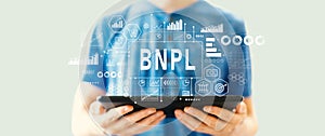 BNPL - Buy Now Pay Later theme with man using a tablet