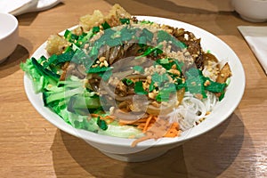 Bo Bun dish with chicken stick and fried chicken spring rolls