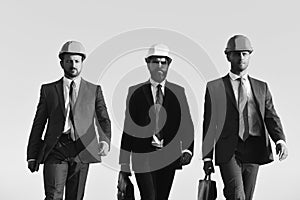 Board of architects wear suits, ties and hardhats