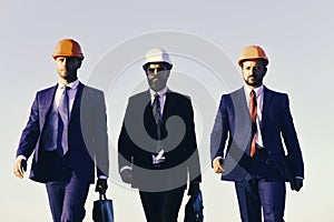 Board of architects wear suits, ties and hardhats