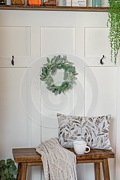 Board and batten accent wall with a small decorative bench