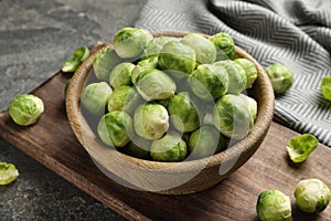 Board with bowl of Brussels sprouts on table