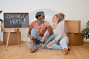 Board, box or happy couple laughing in new house in real estate, property investment or buying apartment. Our first home