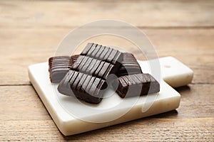 Board with delicious and healthy hematogen on wooden table, closeup