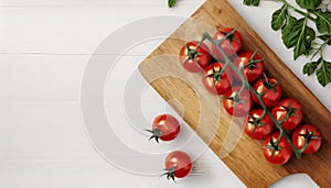 Board with fresh cherry tomatoes on white background with copy space