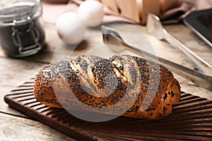 Board with freshly baked poppy seed roll